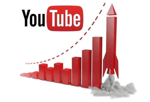 Laptop showing YouTube Studio analytics with a microphone, representing a faceless YouTube channel setup