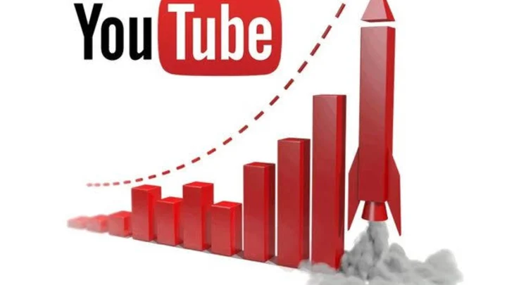 Laptop showing YouTube Studio analytics with a microphone, representing a faceless YouTube channel setup